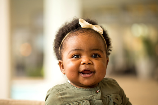 Baby smiling and missing a tooth.