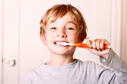 Blonde boy brushing teeth