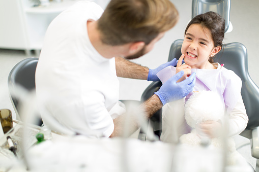 Little girl smiling at dentist at NC Pediatric Dentistry in Mooresville, NC