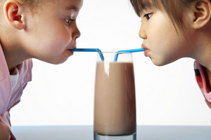 Adorable little girls drinking milk