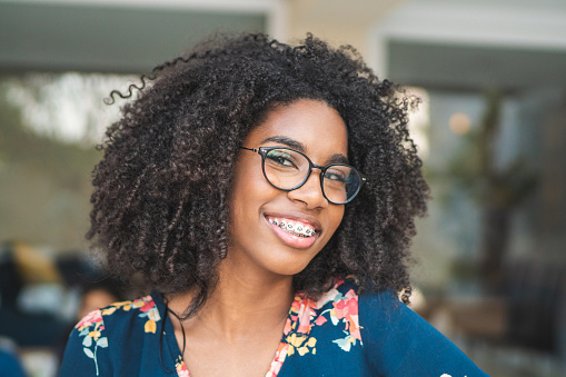 Beautiful Black teenage girl with braces smiling