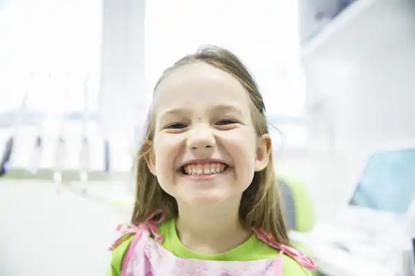 Little girl smiling after fluoride treatment