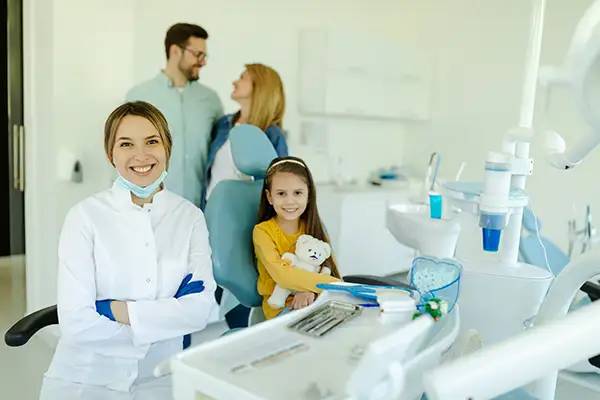 A young girl sitting in a dentist chair during a checkup.