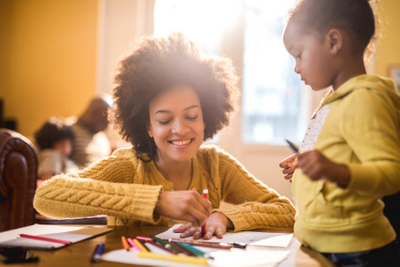 Black mom and daughter at home playing
