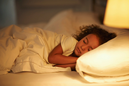 Beautiful curly haired Black girl sleeping