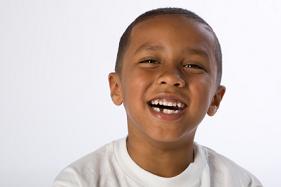 Smiling child with a missing tooth.